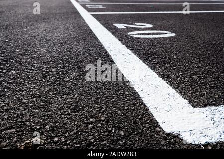 Number 20, painted on the paved ground of a parking lot with white paint. Stock Photo