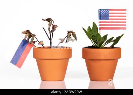 flags of usa and russia in a flowerpot with drought flower, conceptpeanlties or punitive tariff or bad purchasing power. symbol for a bad economy of a Stock Photo