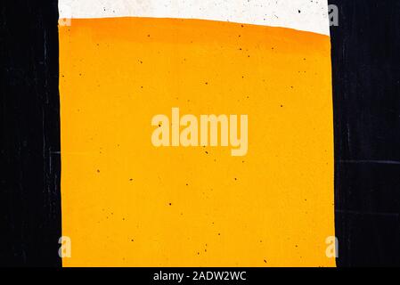 Textured background of a wall painted with black, orange and white lines. Stock Photo