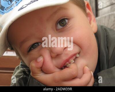 A boy portrait. Sillly face expression, wide eyes, funny lips. Stock Photo