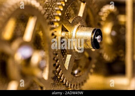 Closeup of brassy Gears, concept Teamwork and Togetherness, golden background Stock Photo
