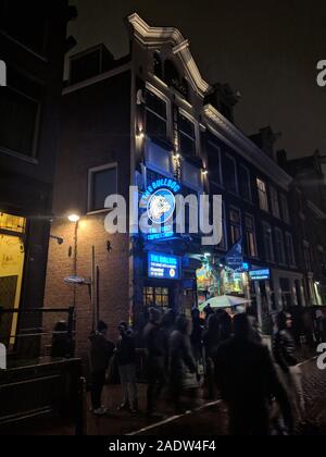 AMSTERDAM, NETHERLANDS, January 2019, People infront of Bulldog, the first ever legal weed shop in city Stock Photo