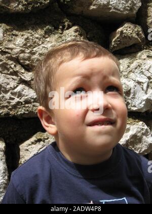 A boy portrait. Sillly face expression, wide eyes, funny lips. Stock Photo