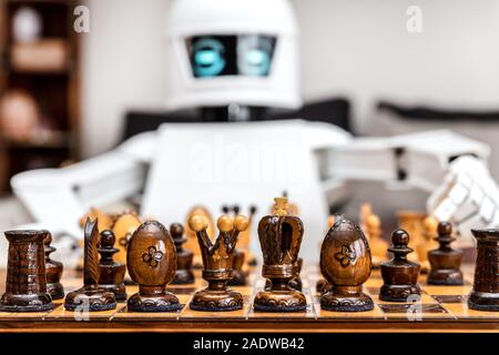 autonomous cyborg or roboter is playing chess, concept strategy or adaptive ki with chess computer Stock Photo