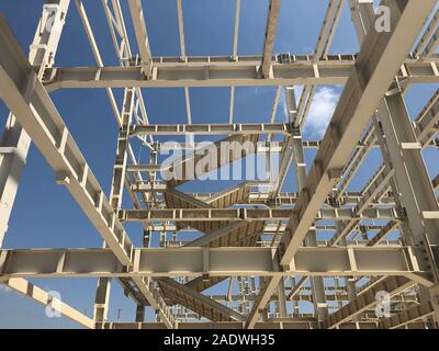 Metal frame of prefabricated multi-storey building. Metal pillars, beams, diagonal bracings and ladders