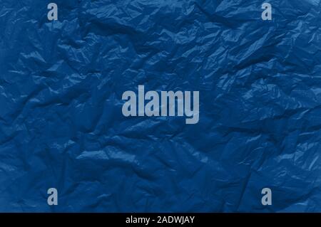 Abstract background in blue. Crumpled plastic surface. Top view.