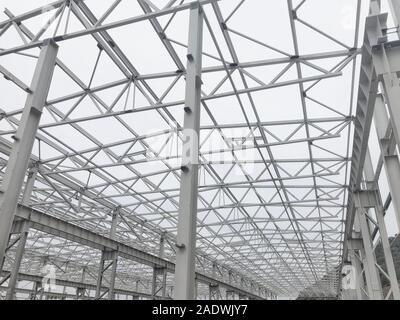 Metal frame of prefabricated multi-storey building. Metal pillars, beams and diagonal bracings