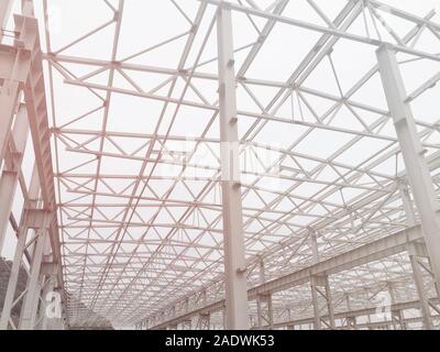 Metal frame of prefabricated multi-storey building. Metal pillars, beams and diagonal bracings