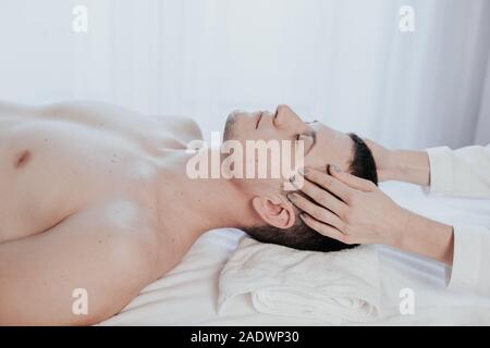 male masseuse makes a therapeutic massage Spa Stock Photo