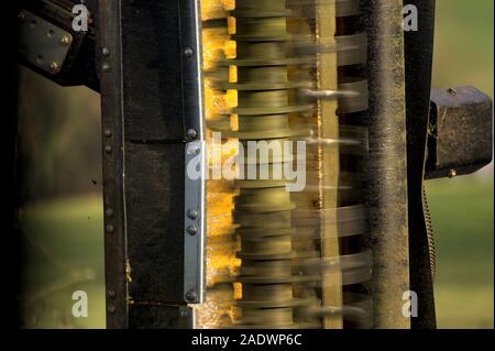 underside showing the fast spinning blades of a tractor hedge cutting arm Stock Photo