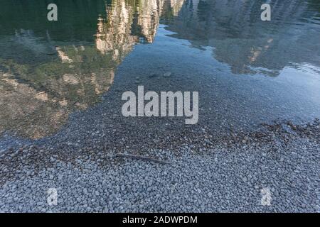 Reflections of the Dolomite mountains on the Braies lake Stock Photo