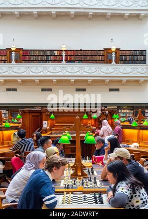 People playing a game of chess in the La Trobe Reading Room of the State Library Victoria Melbourne Australia. Stock Photo