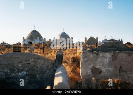 Traditional Kazakh muslim cemetery with old mud brick mausoleums in Kazakhstan Stock Photo