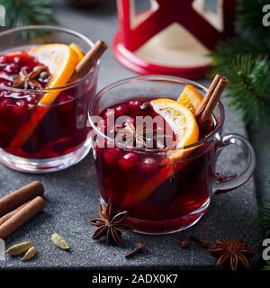 Mulled red wine with spices. Christmas decoration. Grey stone background. Close up Stock Photo