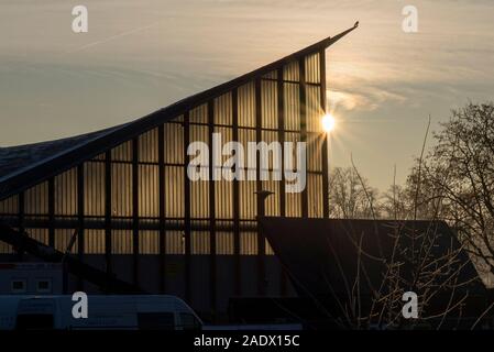 Magdeburg, Germany. 05th Dec, 2019. Behind the hypar dish, the sun rises. The listed building has been renovated since this week. Planned total costs: 17 million euros. According to the plan, the work will be completed in the summer of 2022. Credit: Stephan Schulz/dpa-Zentralbild/ZB/dpa/Alamy Live News Stock Photo