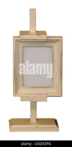 Retro wooden easel with empty small painting frame isolated on white Stock Photo