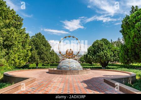 Khujand Arbob Cultural Palace Picturesque Breathtaking View of a Tajikistan Coat of Arms Sculpture on a Sunny Blue Sky Day Stock Photo