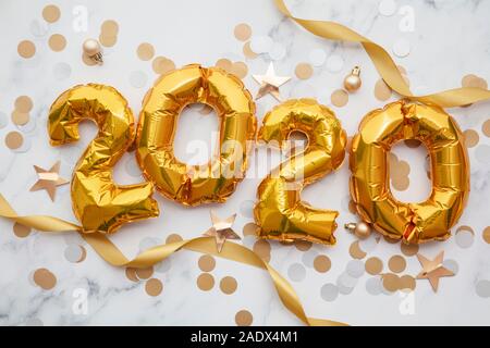 New Year 2020 celebration. Gold foil party balloons with decorations Stock Photo
