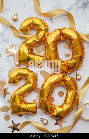 New Year 2020 celebration. Gold foil party balloons with decorations Stock Photo