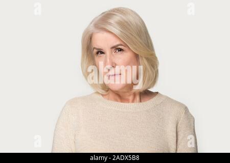 Head shot of angry old woman looking at camera Stock Photo