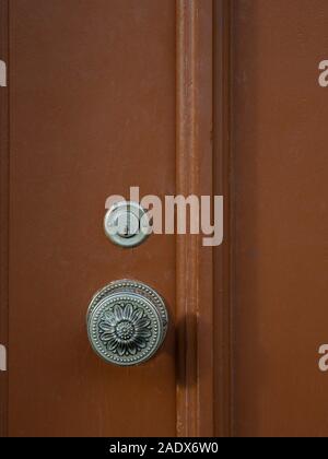 Door knob and keyhole on a brown wooden door Stock Photo
