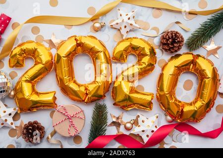 Festive 2020 celebration. Gold foil party balloons with decorations Stock Photo