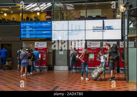 Commuters buying train tickets at Copenhagen Central Station, Copenhagen, Denmark Stock Photo