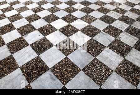 Old aged granite paving tiles. Texture of old granite paving tiles. The texture of the pavement granite pattern wallpaper for design. Rough texture. S Stock Photo