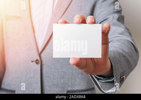 Man's hand holding blank white card close-up Stock Photo