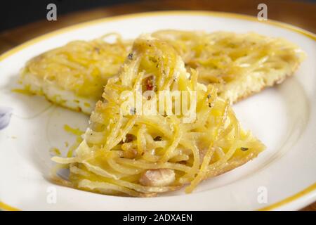 wedge of homemade omelette pasta in a dish wedge of homemade omelette pasta in a dish