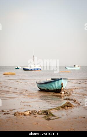 Morecambe Bay fishing boats. Traditional fishing boats resting on the low tide sands of Morecambe Bay on the Lancashire coast in North West England. Stock Photo