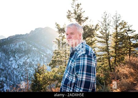 Senior Man Looking Into Distance on a Mountain Walk Stock Photo