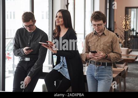 Preparing for exams. Group of students in eyewear standing in the learning room Stock Photo