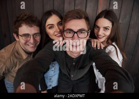 Taking selfie. Close up front view of friends. Man in sunglasses in the room Stock Photo