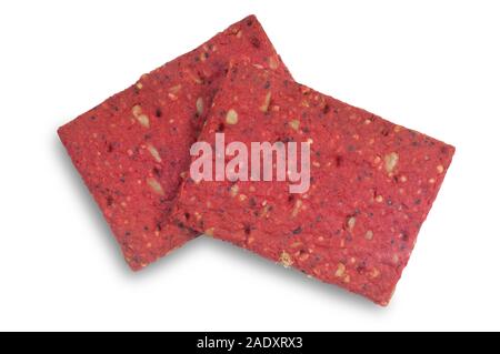 Studio shot of beetroot flavoured oath biscuit containing sunflower, millet and poppy seeds cut out on a white background - John Gollop Stock Photo