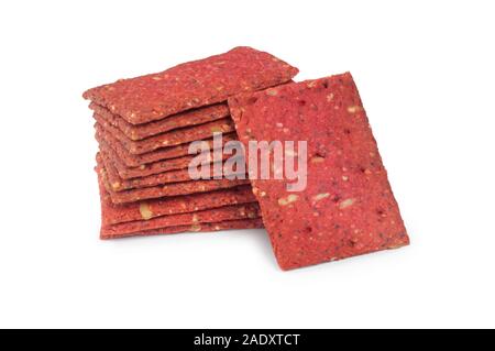 Studio shot of beetroot flavoured oath biscuit containing sunflower, millet and poppy seeds cut out on a white background - John Gollop Stock Photo