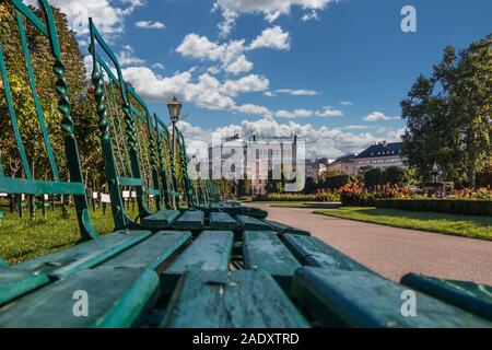 Green chairs in the Volksgarten (People's Garden) in Vienna with a view on the state Theater Burgtheater, Austria Stock Photo