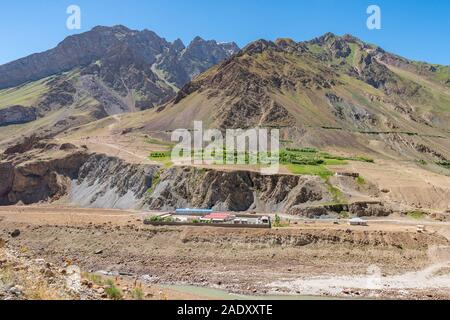 Qalai Khumb to Khorog Pamir Highway Picturesque Panj River Valley View of Tajik Military Camp on a Sunny Blue Sky Day Stock Photo