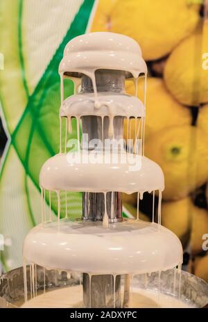 melted white chocolate fountain Stock Photo