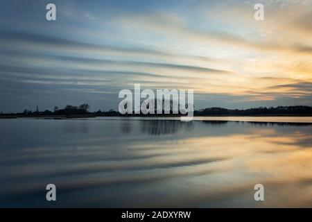 Beautiful evening clouds reflecting in the lake water, Eastern Poland Stock Photo