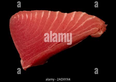 Tuna fillet on black background. Seafood cooking. Useful and tasty food. Stock Photo