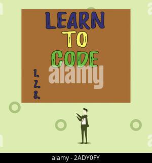 Word writing text Learn To Code. Business photo showcasing Learn to write Software Be a Computer Programmer Coder Isolated view young man standing poi Stock Photo