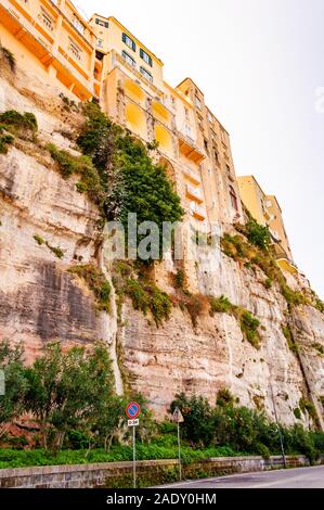 Famous sea promenade in Tropea with high cliffs with built on top city buildings and apartments. Overgrown with southern plants rocks as strong founda