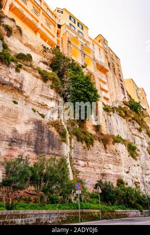 Famous sea promenade in Tropea with high cliffs with built on top city buildings and apartments. Overgrown with southern plants rocks as strong founda