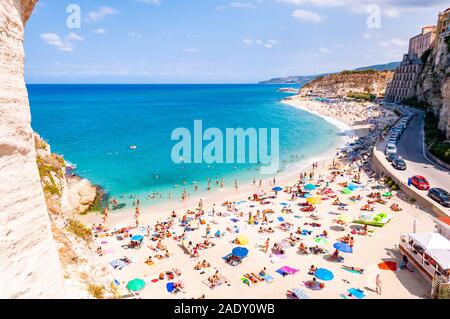 Tropea, Calabria, Italy - September 07, 2019: Rotonda beach full of people. Amazing Italian beaches. Sea promenade scenery in Tropea with high cliffs Stock Photo