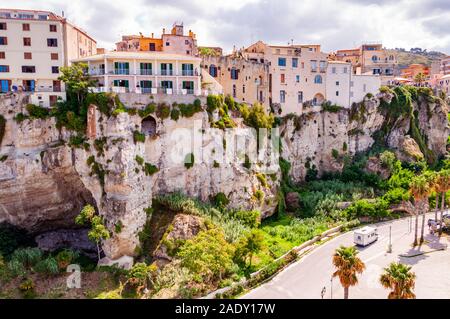 Famous sea promenade in Tropea with high cliffs with built on top city buildings and apartments. Parking area on the street. Amazing Italian cityscape