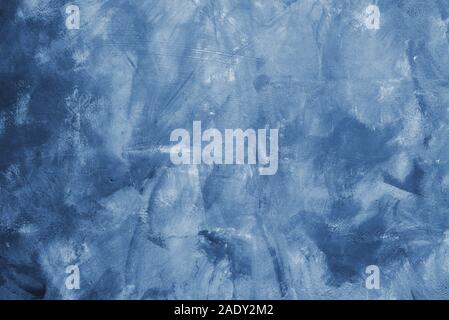 Smears of classic blue paint on the wall. Concrete designer wall color 2020. Fashionable classic blue pantone color of spring-summer 2020 season from Stock Photo