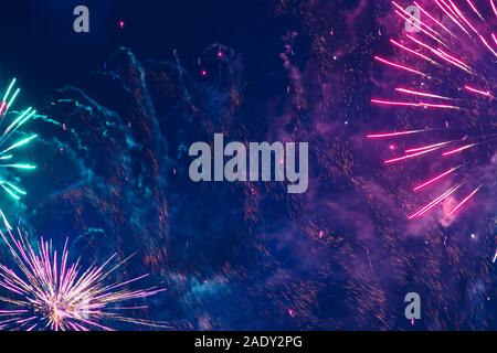 Inexpensive fireworks, over the city, red green abd green. Motion blur. Light flares. For any purpose Stock Photo