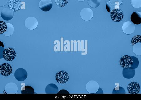 Carnival decorations classic confetti on blue color festive background. Trendy holiday New Year 2020. Flat lay. Stock Photo