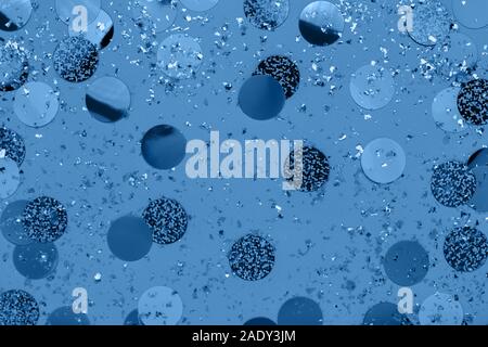 Carnival decorations classic confetti and sparkles on blue color background. Trendy holiday New Year 2020. Flat lay. Stock Photo
